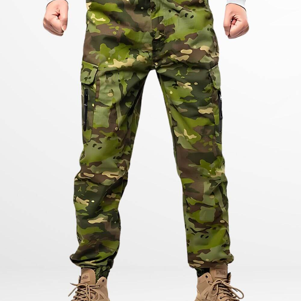 Man wearing camo cargo hunting pants paired with tan tactical boots, featuring a green and brown camouflage pattern ideal for outdoor hunting activities.