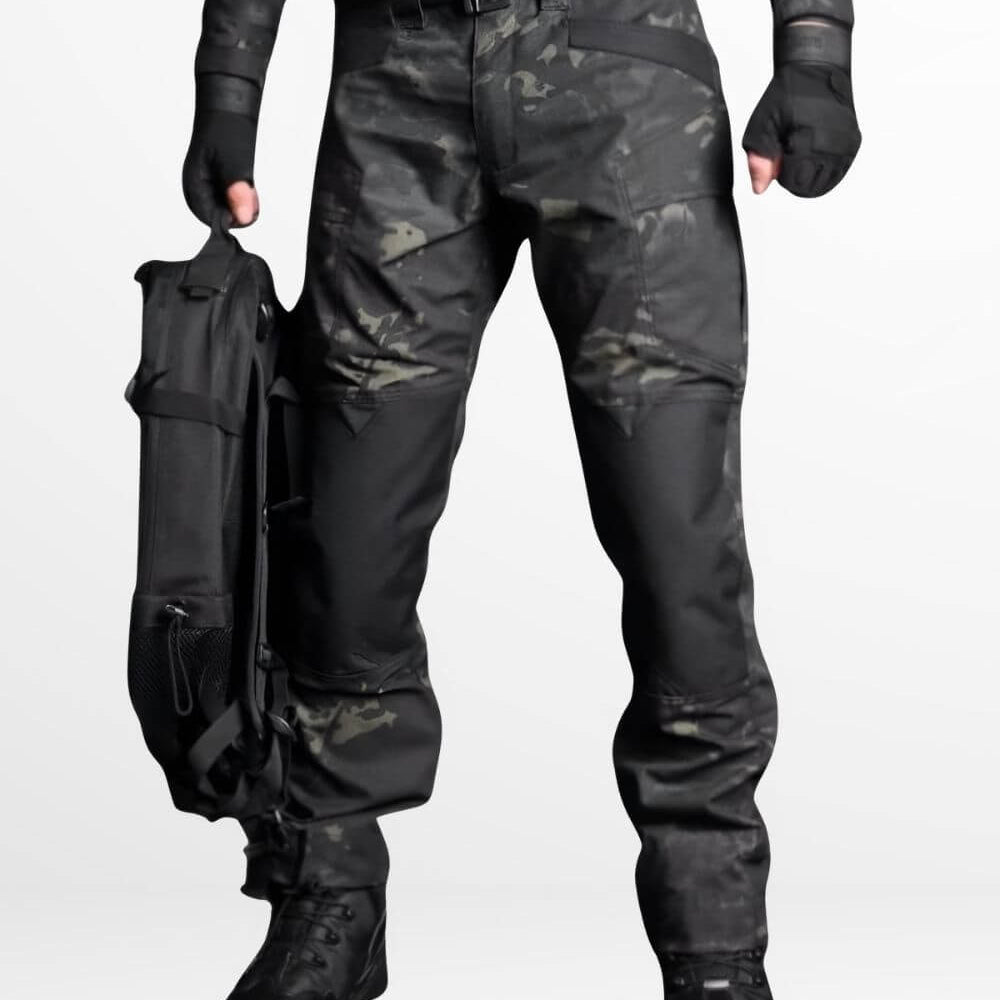 Man wearing camo cargo pants with a tactical bag, ideal for outdoor activities, featured in a dark camouflage pattern with durable boots for rugged terrain.