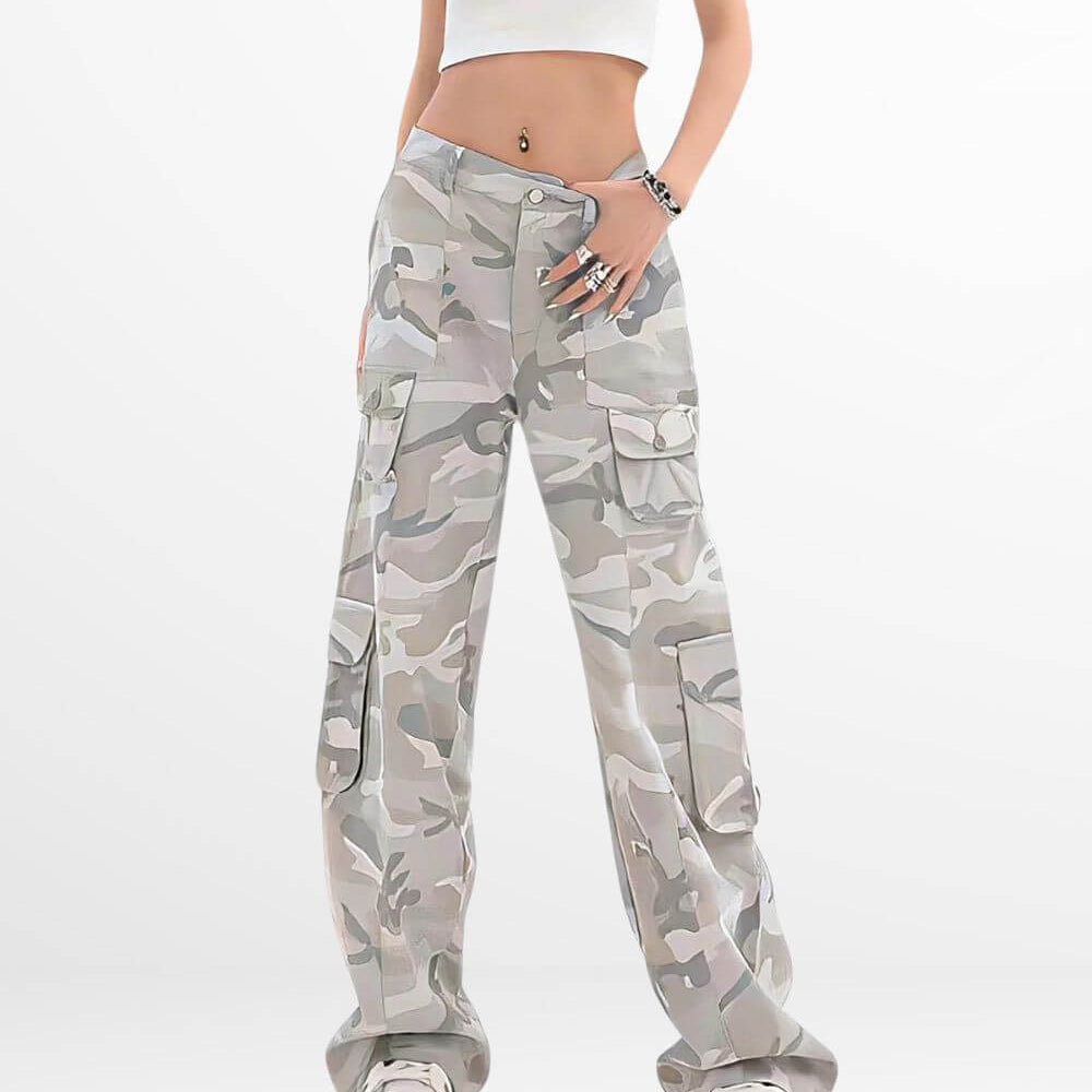 Woman wearing trendy camo cargo pants in a light grey and white camouflage pattern, paired with white sneakers, perfect for a fashionable street style look.