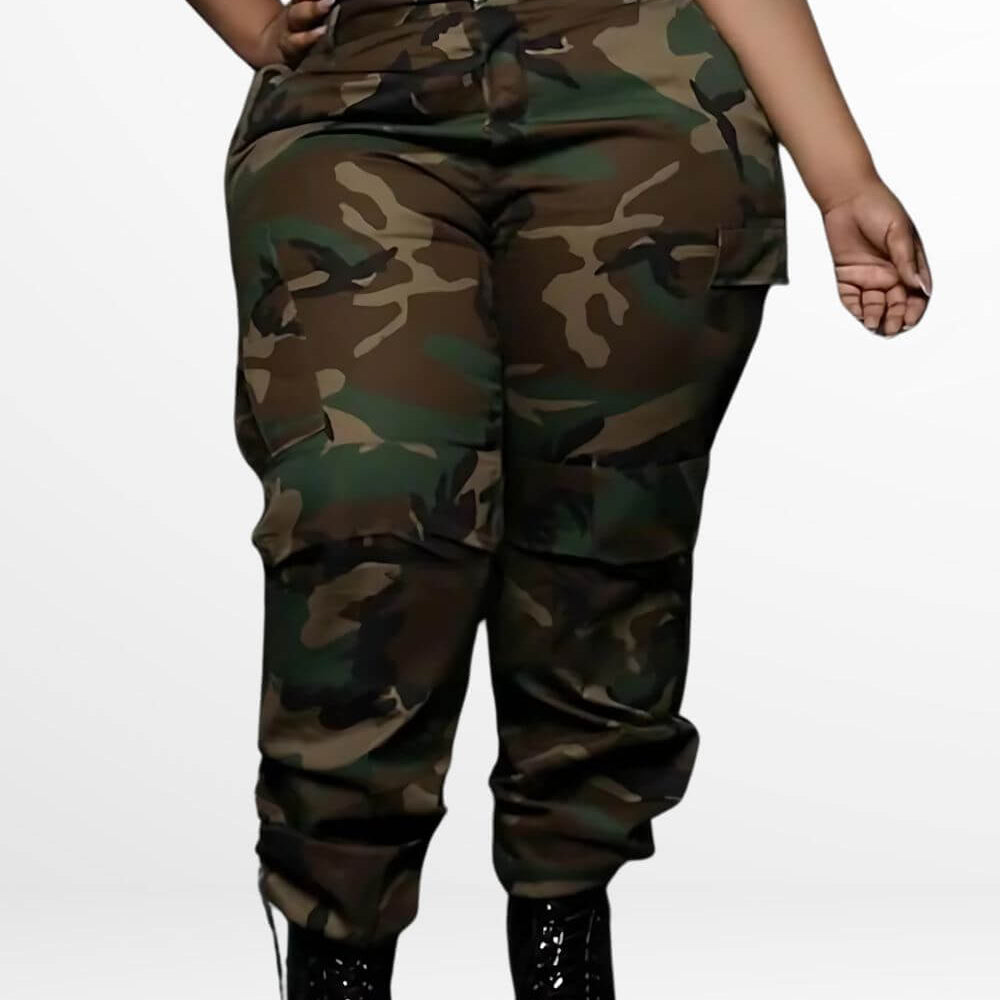 Woman wearing plus-size camo cargo pants paired with glossy black boots, showcasing a comfortable and stylish look with a classic green and brown camouflage pattern.