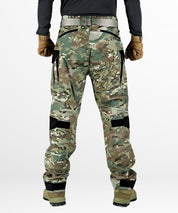 Back view of women's cargo camo pants showcasing grey camouflage print and utility pockets, styled with a black tank top and white trainers.