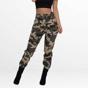 Front view of Camo Cargo Pants High-Waisted in khaki camo print, featuring a secure waist and cargo pockets, styled with a black crop top and high heels.