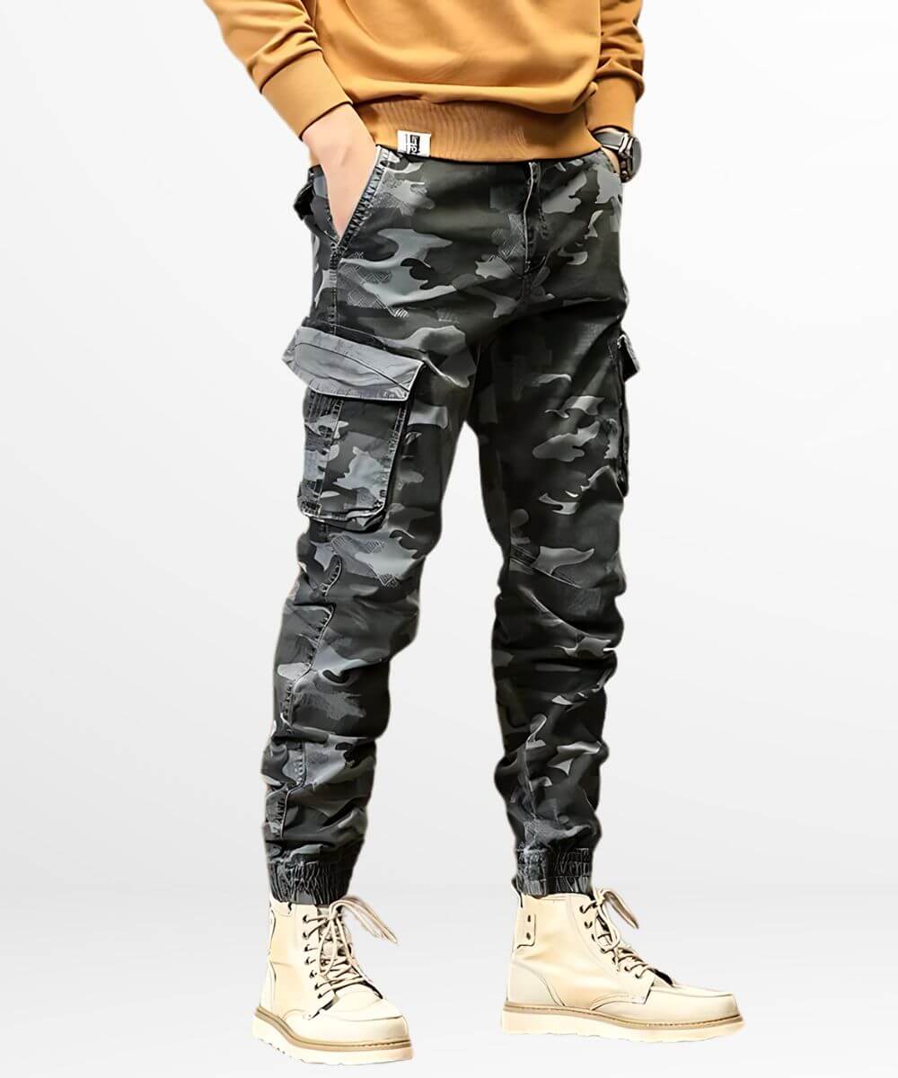 Full-body view of a person wearing men's grey camo cargo pants paired with stylish cream boots.