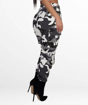 Women's black and white camo cargo pants paired with high heels for a modern, stylish look.