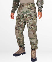 Front view of army camo cargo pants with integrated combat knee pads and tactical boots, ideal for military and outdoor activities.
