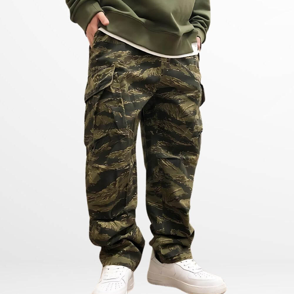 Close-up of baggy camo cargo pants complemented by crisp white sneakers for a streetwear vibe.