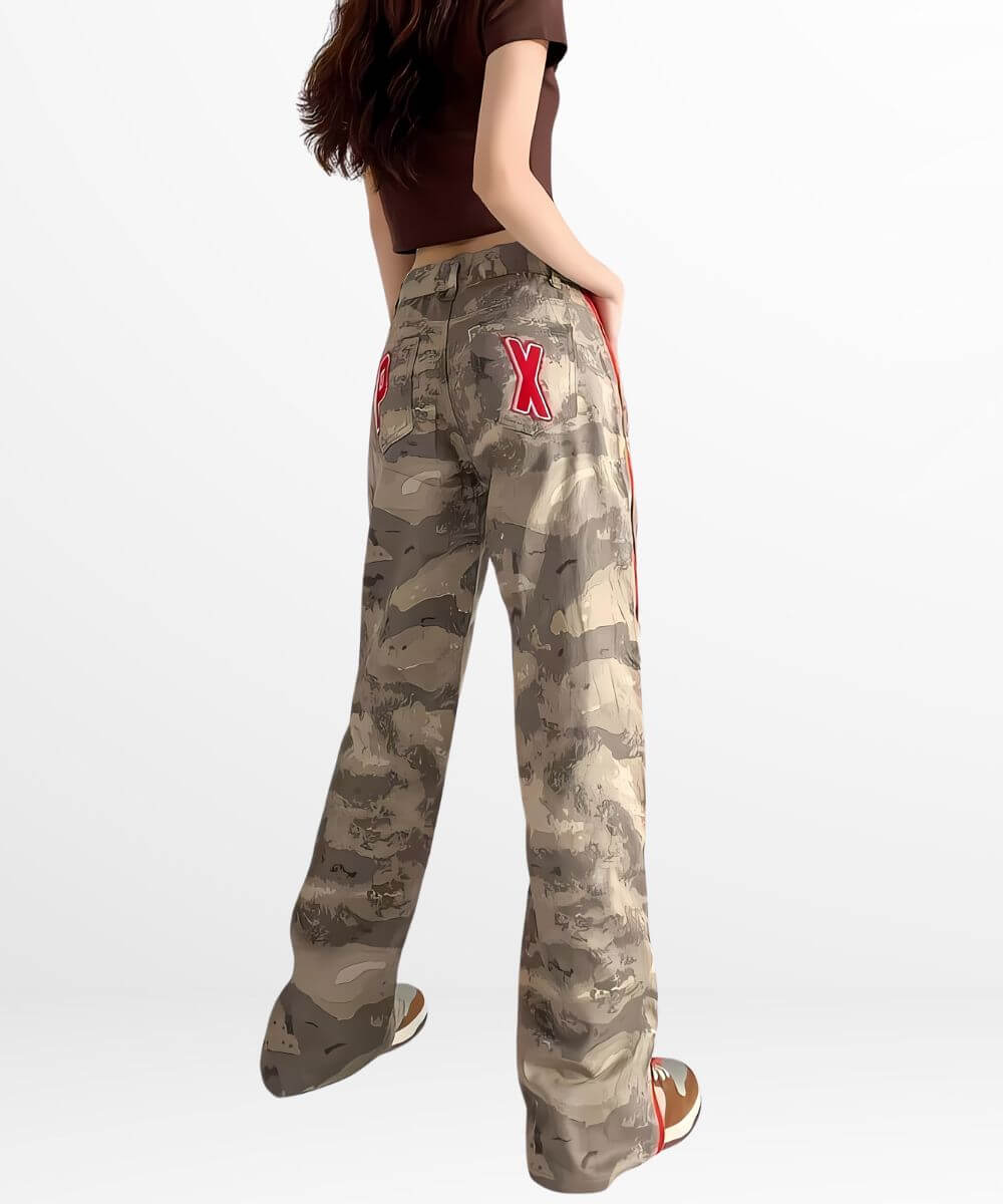 Rear view of baggy camo cargo pants for women with a prominent red 'X' on the pocket, highlighting the loose fit and unique design.