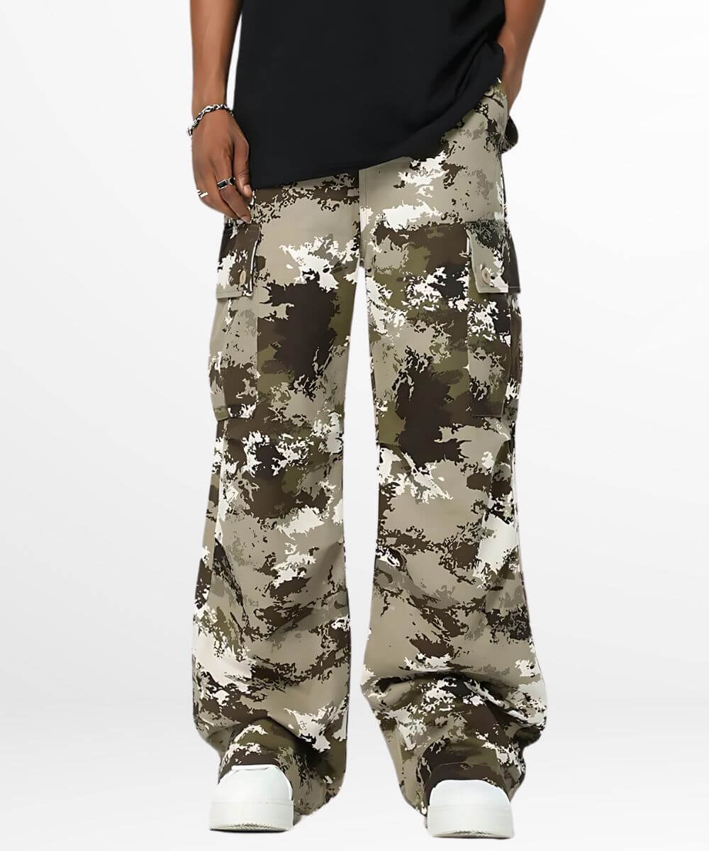 front view of baggy camouflage pants with detailed side pockets and white sneakers.