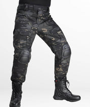 Side view of black camo hunting pants with built-in knee pads and rugged design.