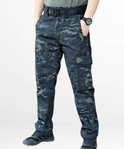 Front view of black camo military pants with tactical pockets and a robust belt, paired with athletic shoes.