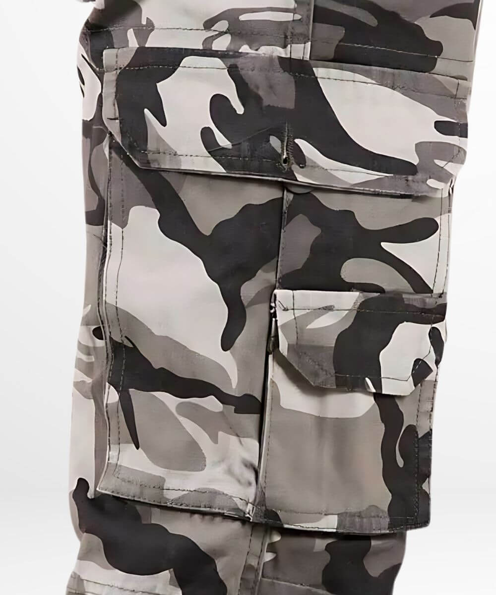 Close-up on the cargo pocket detail of black, grey, and white camo cargo pants, showing fabric texture and pattern.
