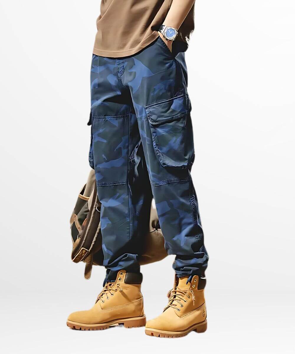 Man wearing blue camouflage cargo pants with tan boots, fashionable outfit.