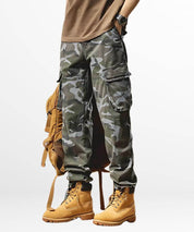 Casual style men's blue camouflage pants paired with tan lace-up boots.