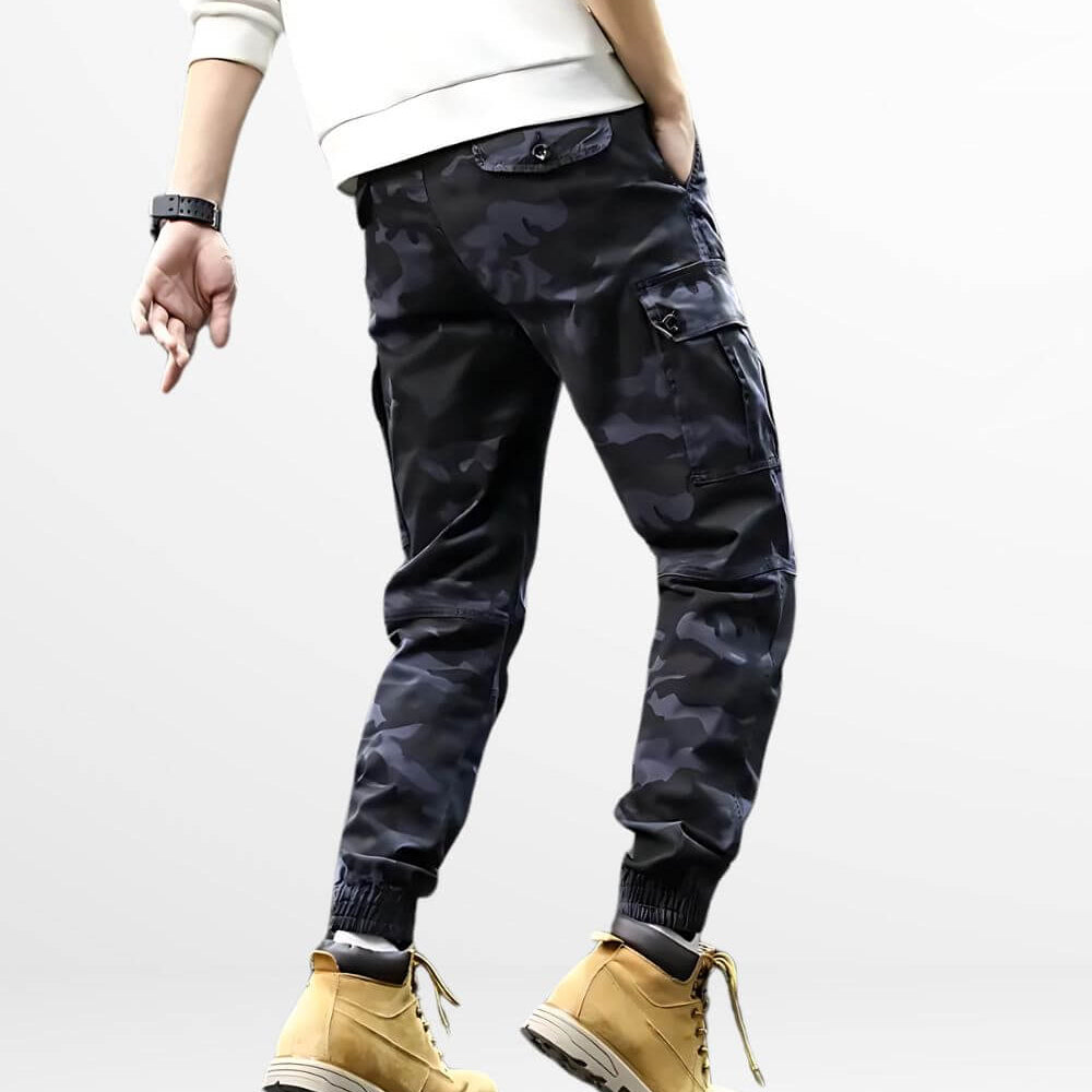 Back view of men's blue camouflage pants with matching tan work boots and ribbed cuffs.