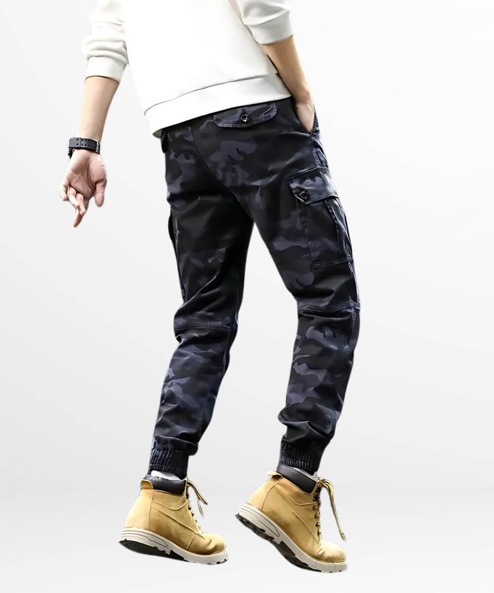 Back view of men's blue camouflage pants with matching tan work boots and ribbed cuffs.