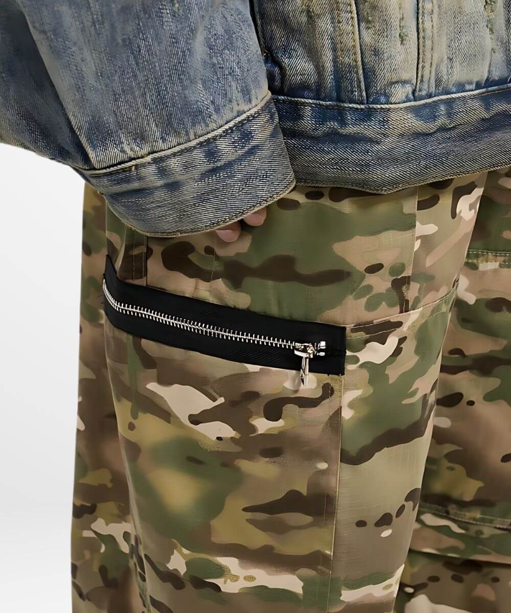 Close-up of a zipper pocket on baggy camouflage pants paired with a denim jacket.