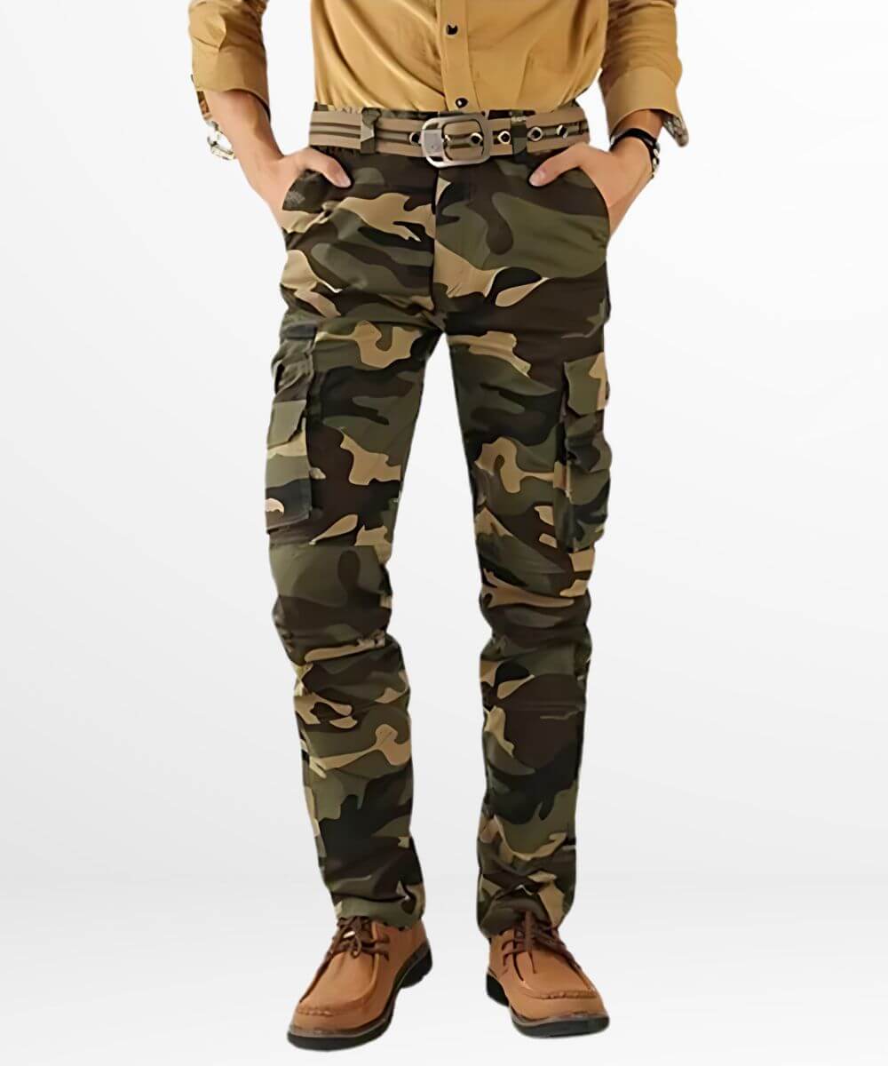 A casual stance in cargo pants for men in a camo pattern, matched with tan shoes and a mustard shirt for a cohesive earth-tone outfit.