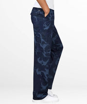 A relaxed stance in navy blue camo cargo pants with a white t-shirt, blending comfort with the urban appeal of camo print for everyday wear.