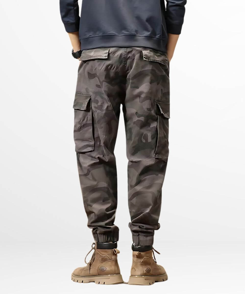 Back view of a casual outfit featuring grey baggy camo cargo pants and stylish ankle boots.