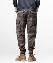 Back view of a casual outfit featuring grey baggy camo cargo pants and stylish ankle boots.