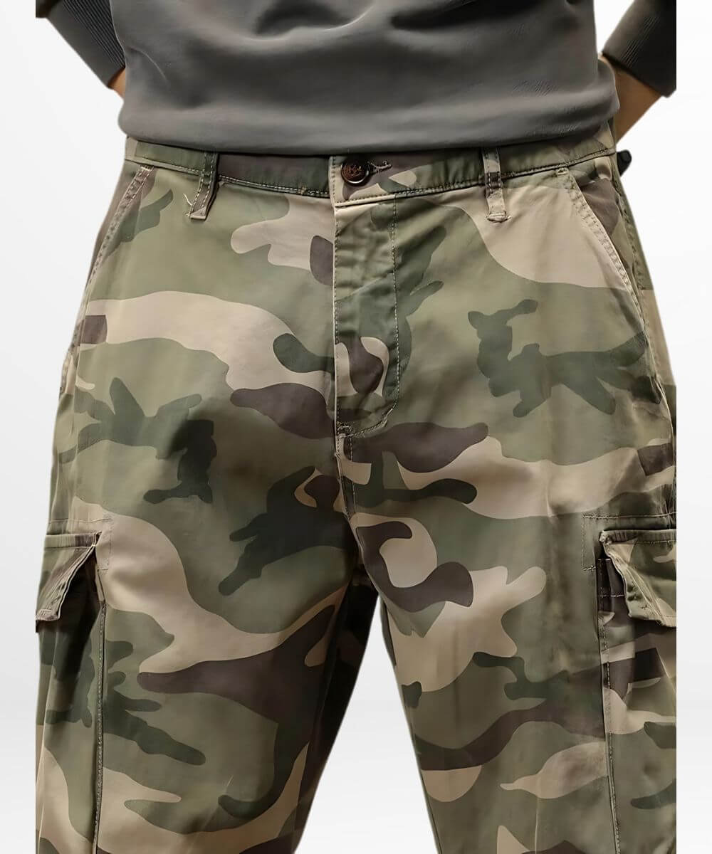 Close-up of the texture and camo pattern on green baggy cargo pants highlighting the quality fabric.