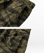 Texture close-up of baggy camouflage cargo pants showing fabric quality and pocket details.