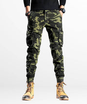 Designer slim camo cargo pants with contrasting trims and tactical pockets, showcased on a fashion-forward male model.