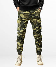 Front view of green camo cargo jogger pants with cuffed ankles, styled with matching cream boots for a cohesive, adventure-ready outfit.