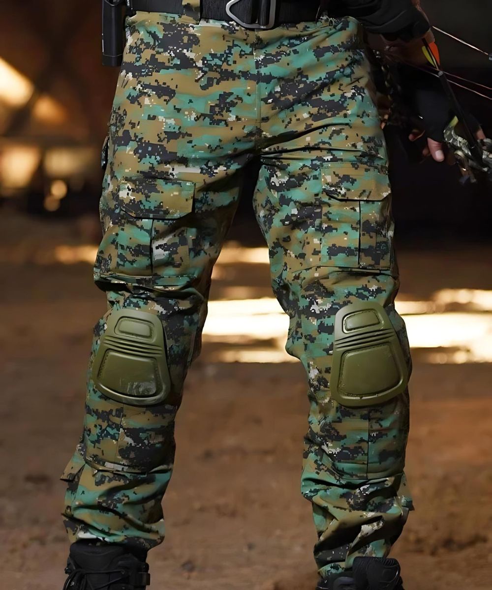 Full gear setup showing digital camo hunting pants with knee pads, worn in a wilderness environment, perfect for hunting or tactical activities.