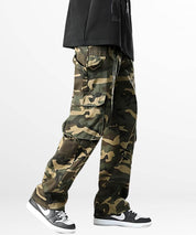 Full-length view of men's baggy camo cargo pants paired with a casual black top, capturing the trendy and functional streetwear vibe.
