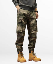 Stylish green baggy camo cargo pants paired with classic Timberland boots for a rugged look.