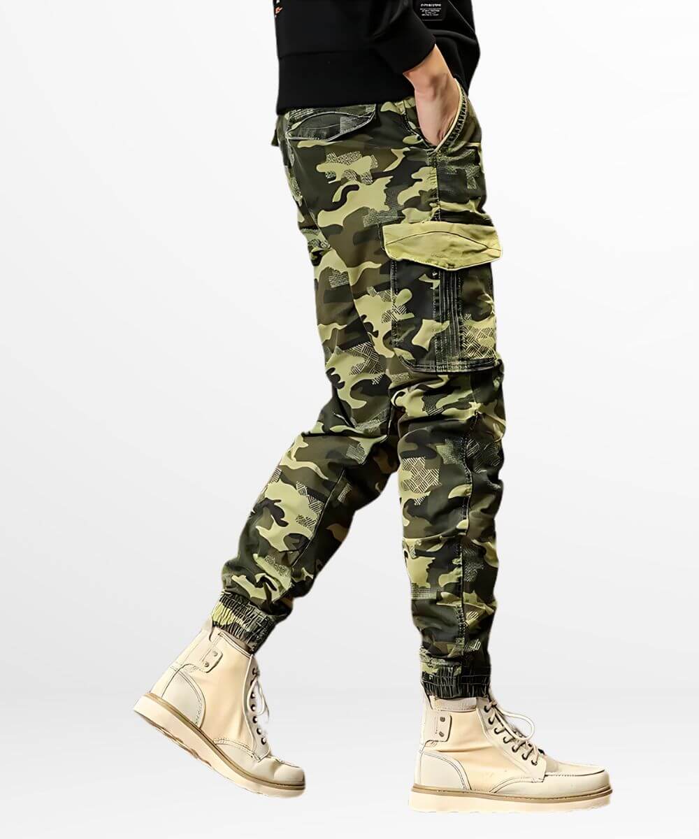 Side view of a person wearing green camo cargo jogger pants, highlighting the utility pocket and the pants' snug fit with stylish cream boots.