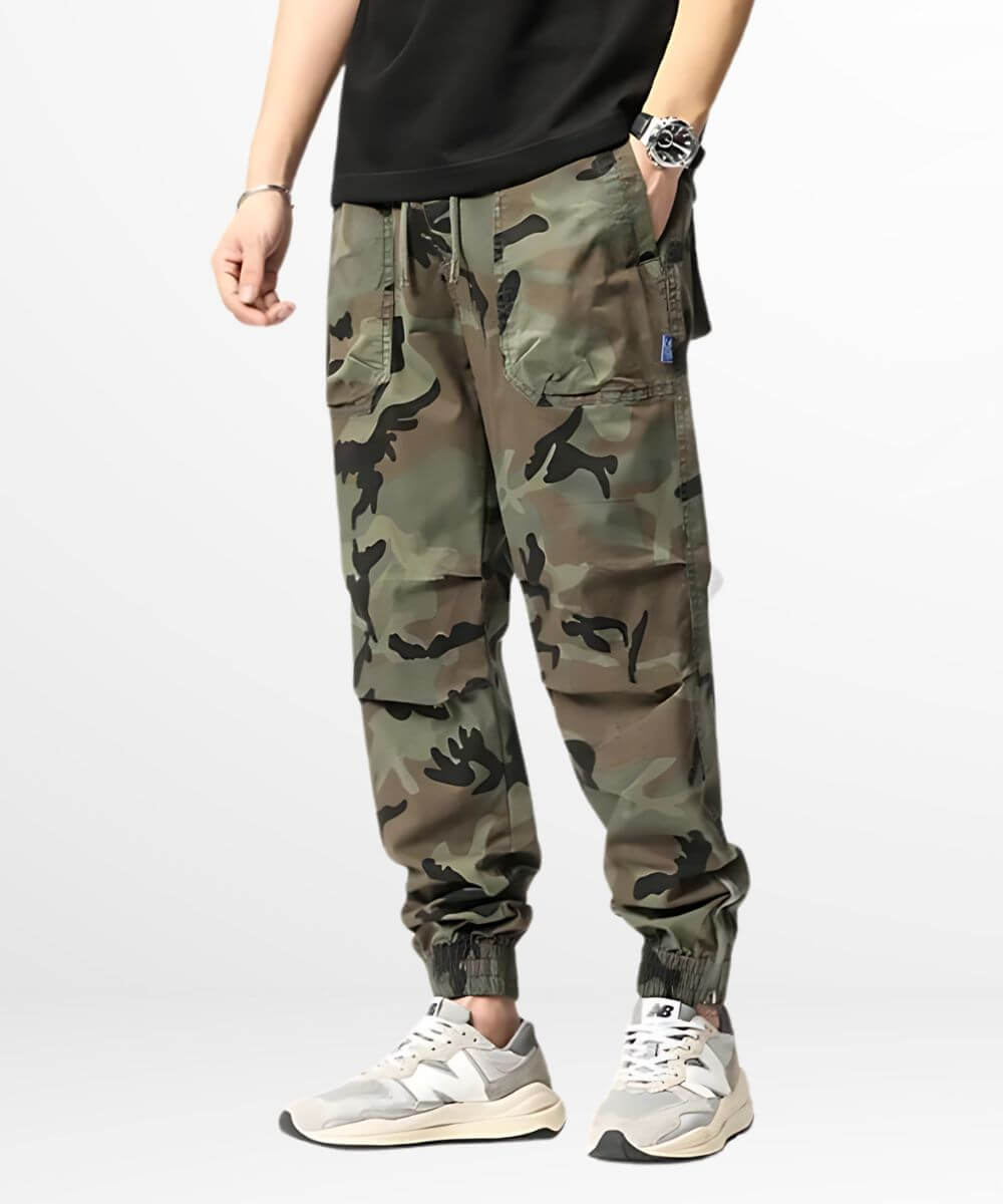 Front view of green camo cargo sweatpants featuring multiple pockets and elastic cuffs, combined with trendy sneakers for a relaxed streetwear vibe.