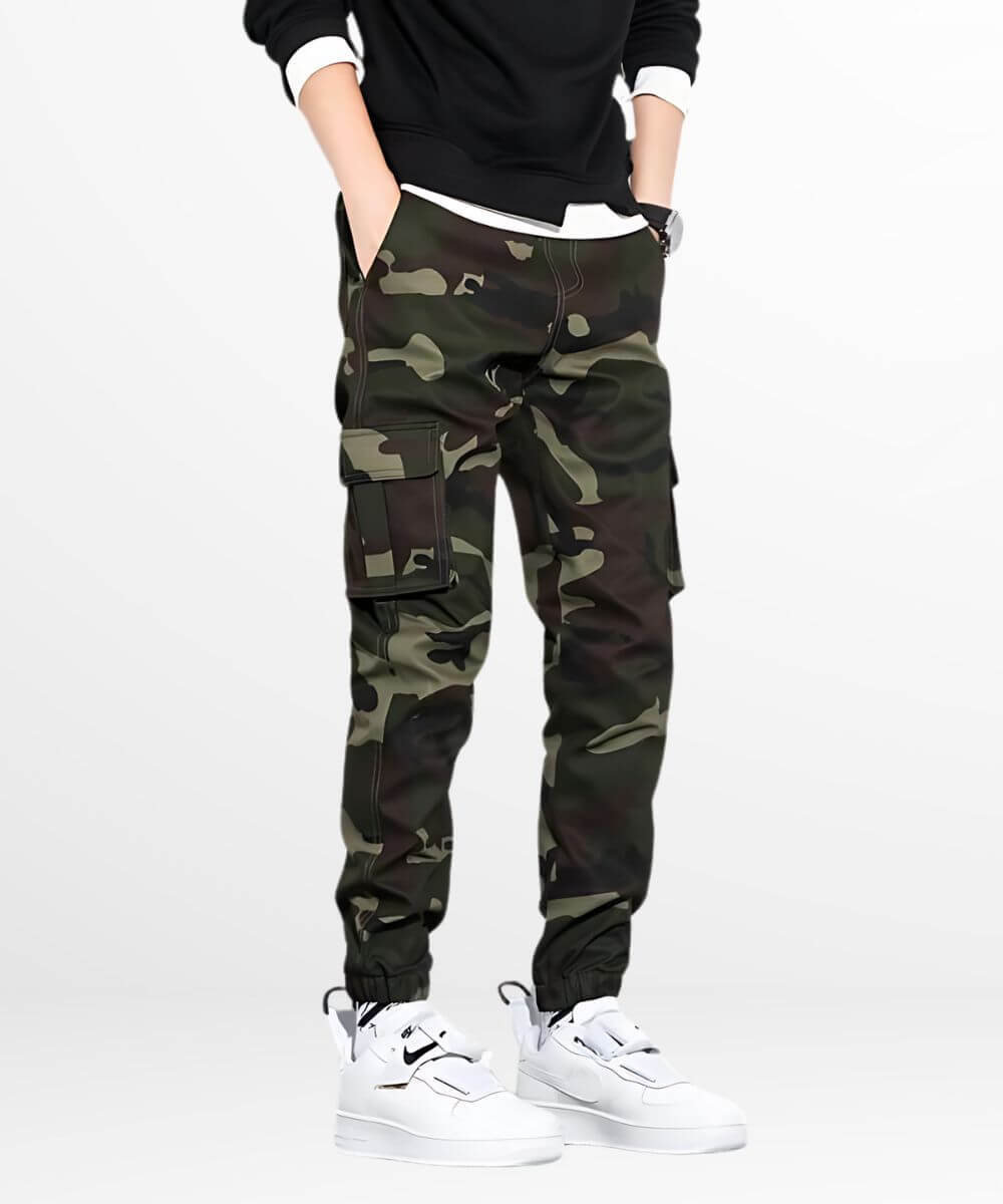 Side profile showcasing green camo pants mens cut with pocket details, matched with trendy white sneakers for daily wear.