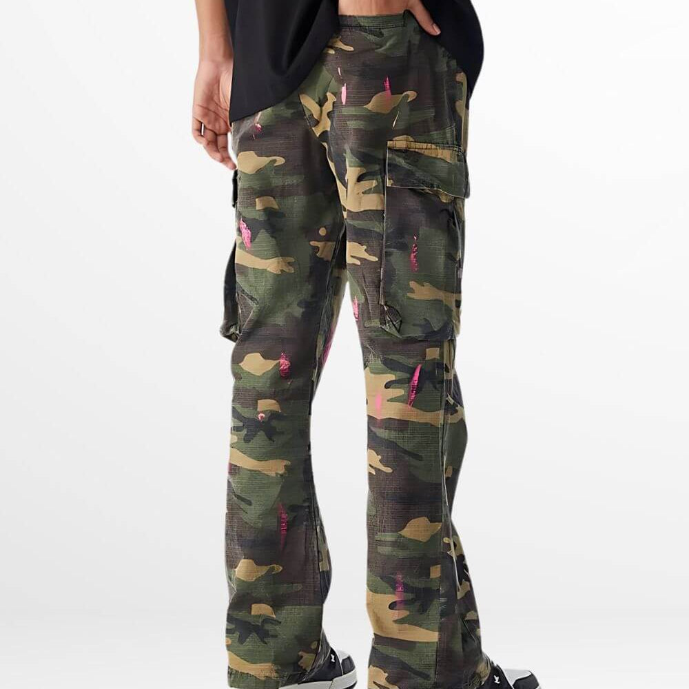 Back view of green and pink camouflage pants highlighting rear pockets and black sneakers.