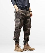 Front view of grey baggy camo cargo pants paired with rugged lace-up boots.