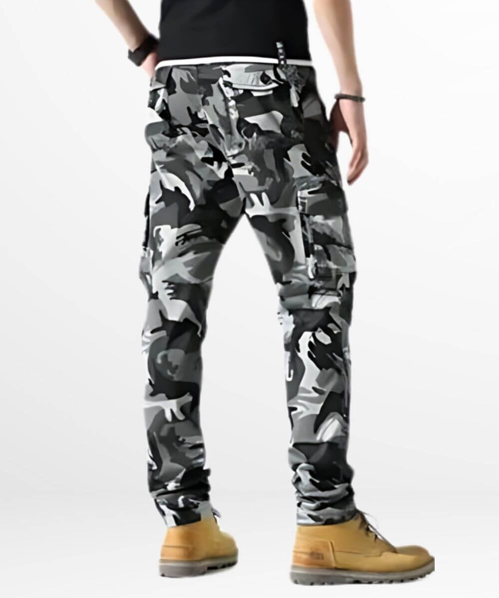 Back view of a man wearing grey and black skinny camo cargo pants highlighting rear design.