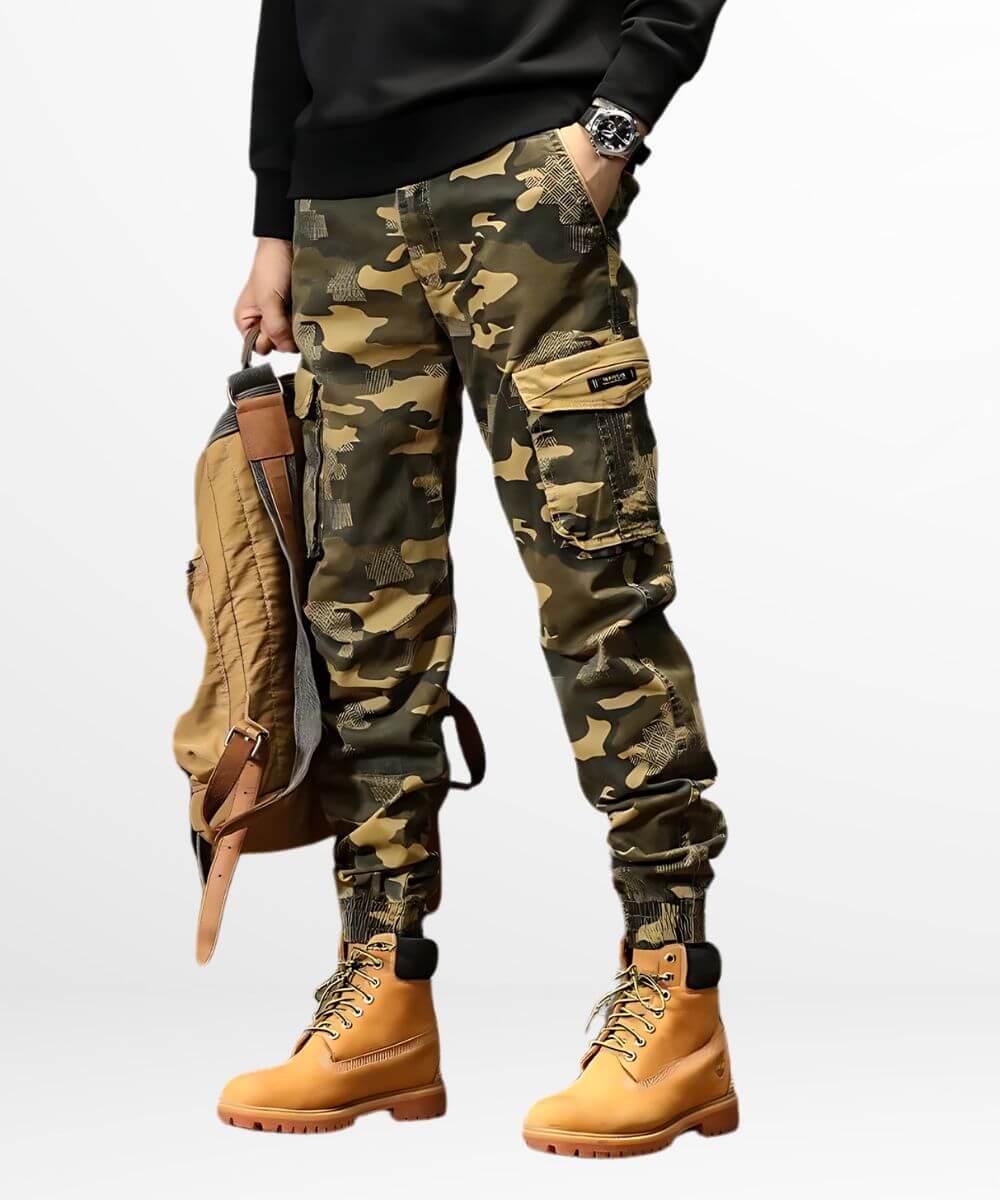A model showcasing khaki camo cargo jogger pants paired with classic tan work boots, accessorized with a matching backpack for a cohesive outdoor look.