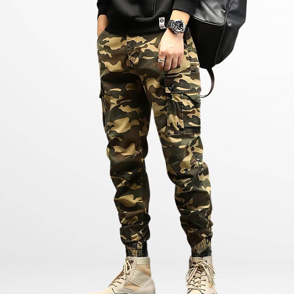 Front view of men's slim-fit khaki camo cargo pants paired with beige combat boots.