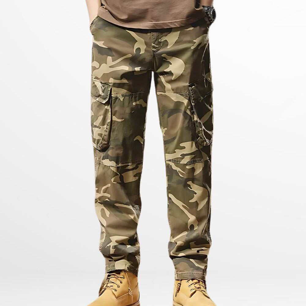 Model showcasing a pair of khaki camo cargo pants with multiple pockets and a modern, tactical design.