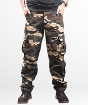 Front view of khaki cargo and camo pants for men with chunky black boots.