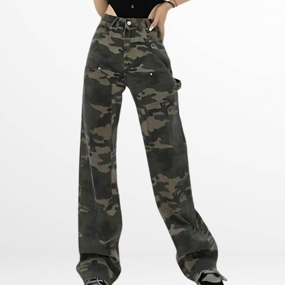 Front view of a woman in loose fit camo cargo pants with a black button-up shirt and classic black and white sneakers.