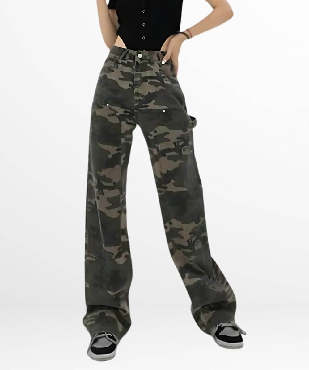 Front view of a woman in loose fit camo cargo pants with a black button-up shirt and classic black and white sneakers.