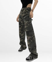 Side view of a woman modeling loose fit camo cargo pants paired with a tight black top and stylish sneakers.