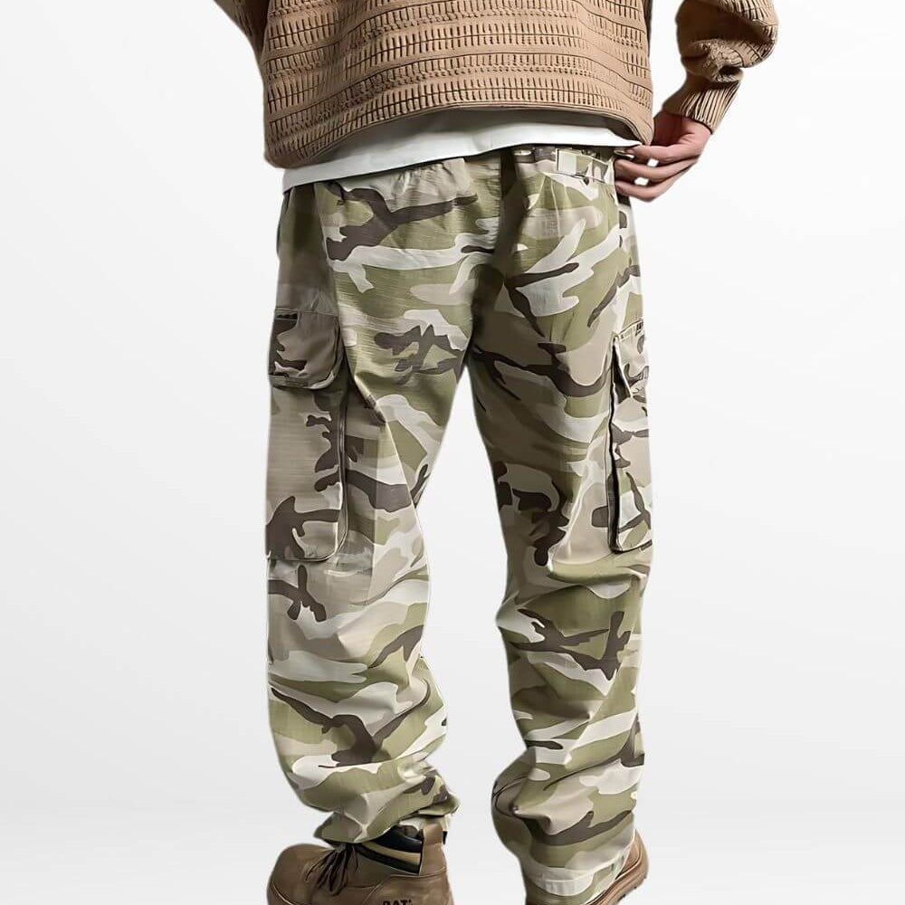 Back view of men's baggy camo pants showing the loose fit and cargo pockets, teamed with durable work boots for a functional outfit.