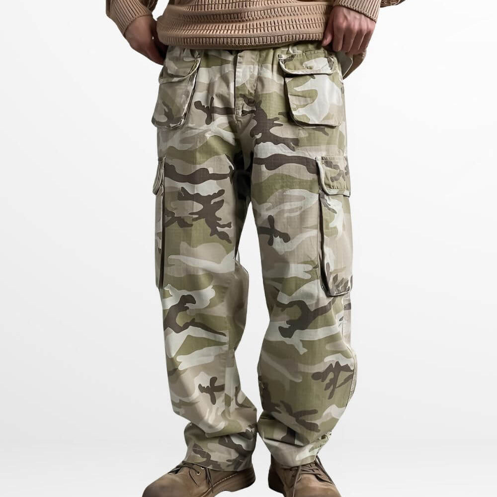Front view of a man wearing men's baggy camo pants paired with brown work boots and a knitted sweater, perfect for a casual, rugged look.