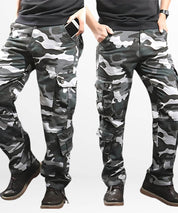 Side view of a man wearing blue camouflage cargo pants, focusing on the side pockets and fit.
