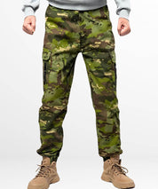 Front view of men's camouflage hunting pants paired with tan tactical boots.
