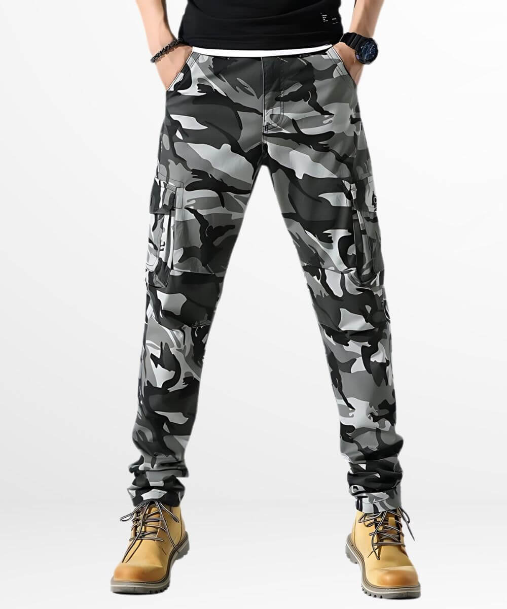 Front view of men's grey and black skinny camo cargo pants paired with tan boots.