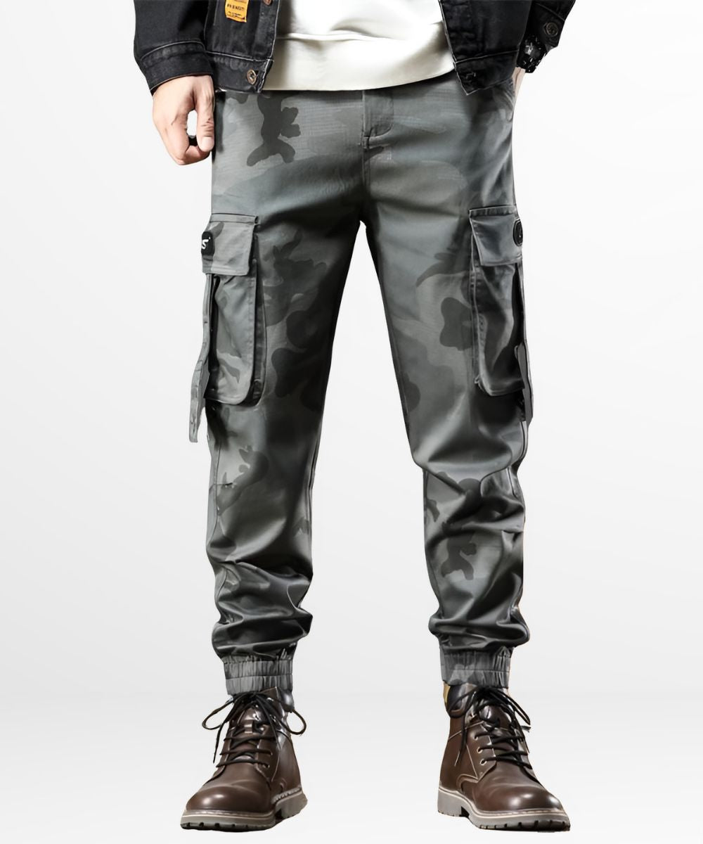 Front view of Men's Grey Camo Cargo Pants styled with lace-up brown boots and a casual jacket.
